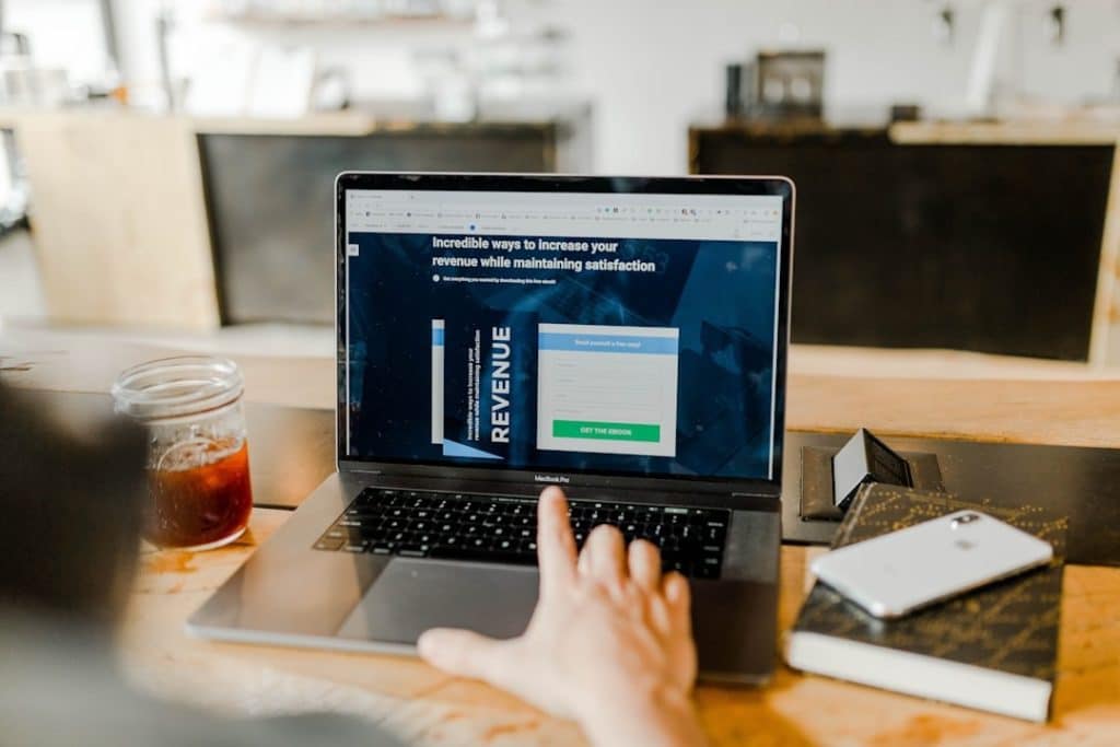 A laptop is used by a person to track the sales cycle of their business.