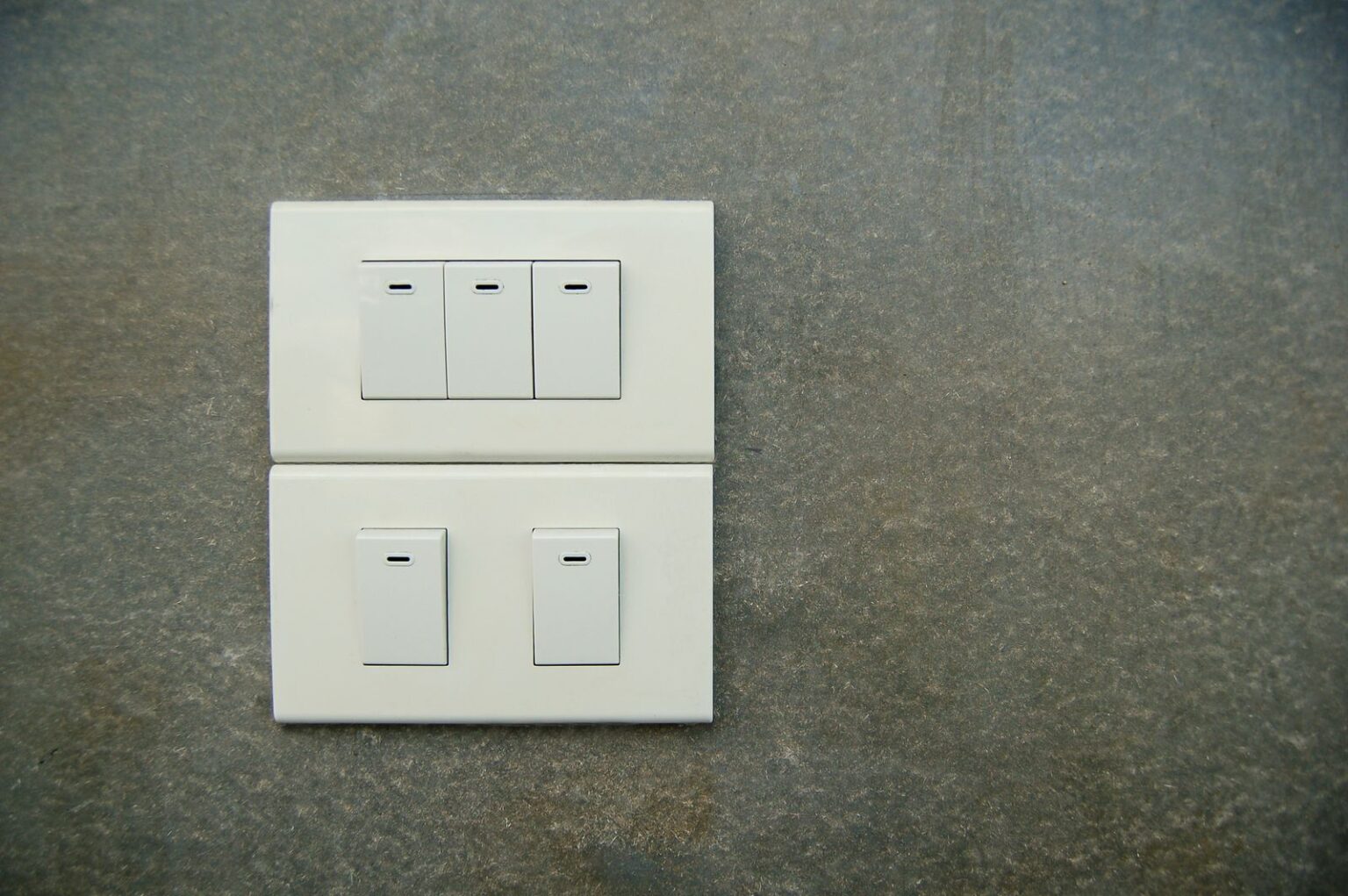 The Real Cost of Leaving Your Lights On Light switch on a wall